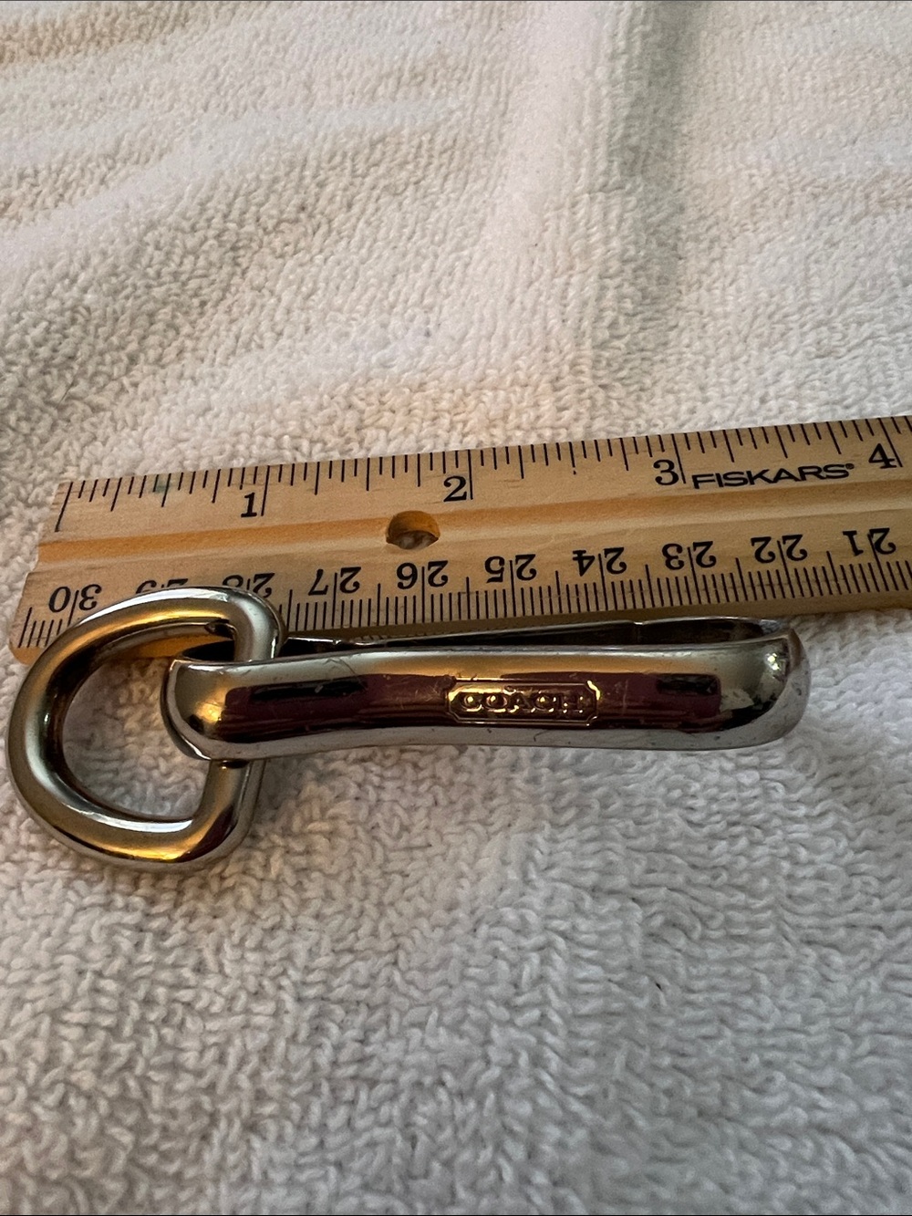 Coach keyring silver-toned carabiner strap fob featuring debossed logo detail